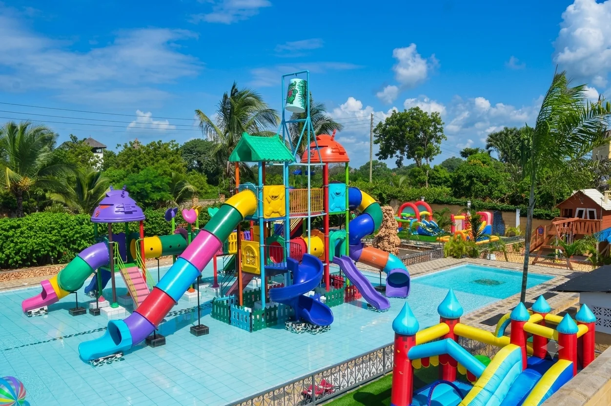 Aerial view of Diani Splash Kids water park showing colourful water slides, the pool area, tropical gardens and the Indian Ocean in the background